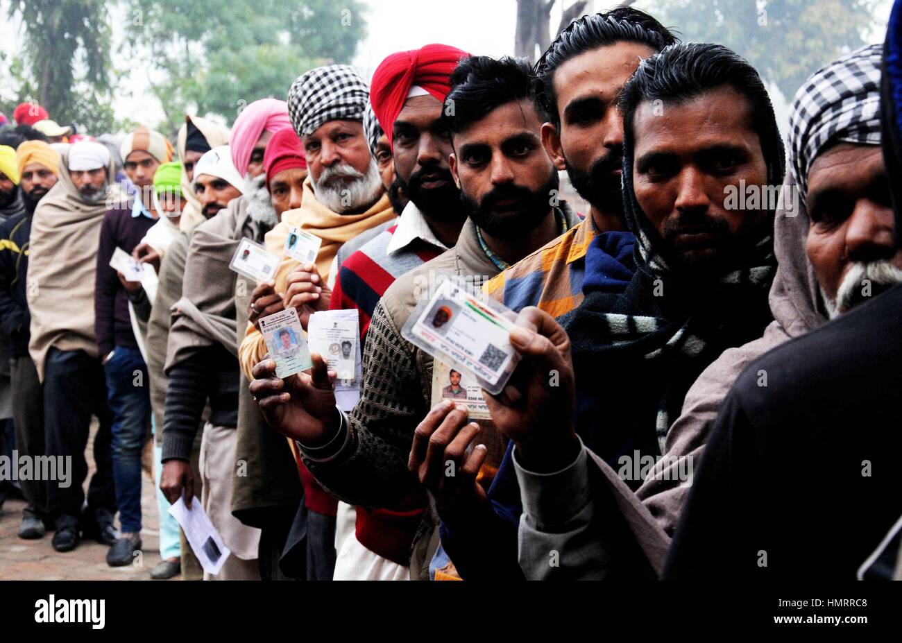 Amritsar, India. 05th Feb, 2017. Indian voters show their identity cards outside a polling booth for assembly election at a village around 25 km from Amritsar, northern Indian state of Punjab, Feb. 4, 2017. Two Indian states, Punjab in the north and Goa in the west, both ruled by the country's ruling Bharatiya Janata Party (BJP), went to polls on Saturday. Credit: Xinhua/Alamy Live News Stock Photo