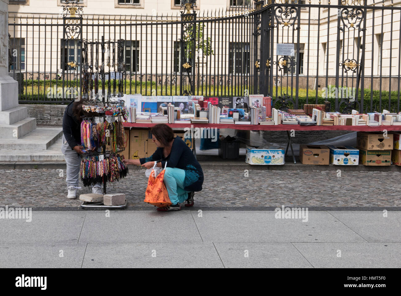 Two women looking at items on sale outside the  Humboldt University, Berlin, Germany Stock Photo
