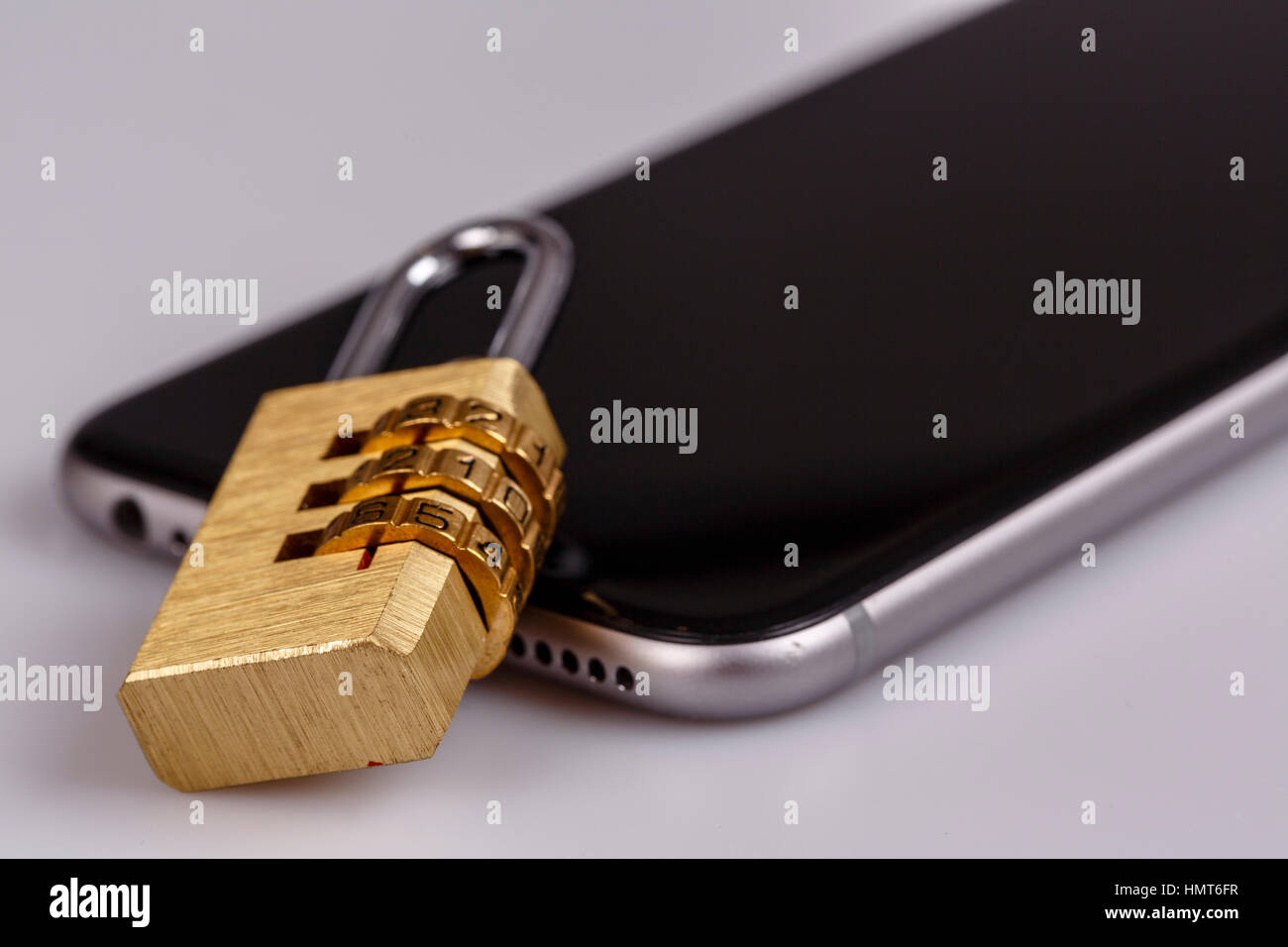 Phone Table Lock cellphone data security - lock and phone on white Stock Photo - Alamy