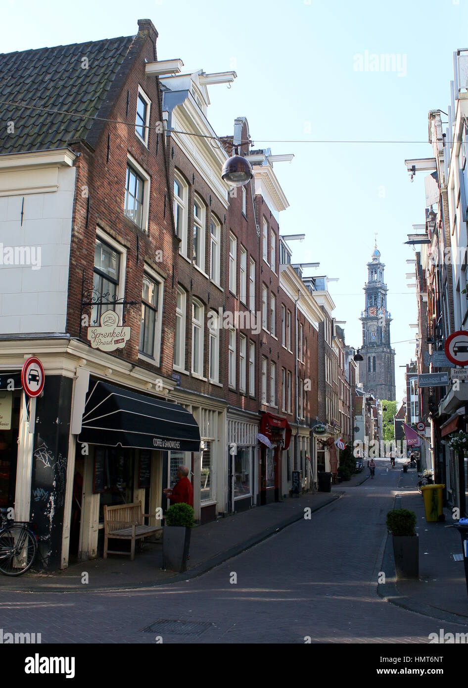 Shops and cafés in the Jordaan quarter in central Amsterdam, Netherlands in summer, Westerkerk tower in background. Stock Photo
