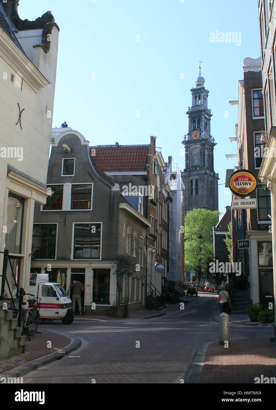 Shops and cafés in the Jordaan quarter in central Amsterdam, Netherlands in summer, Westerkerk tower in background. Stock Photo