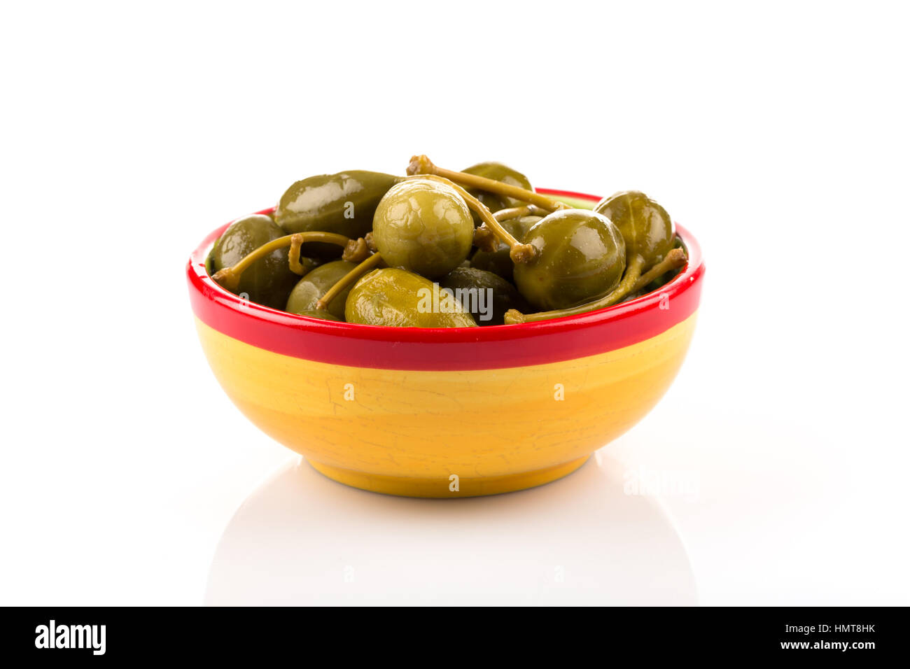 Bowl of canned capers on a white background Stock Photo - Alamy