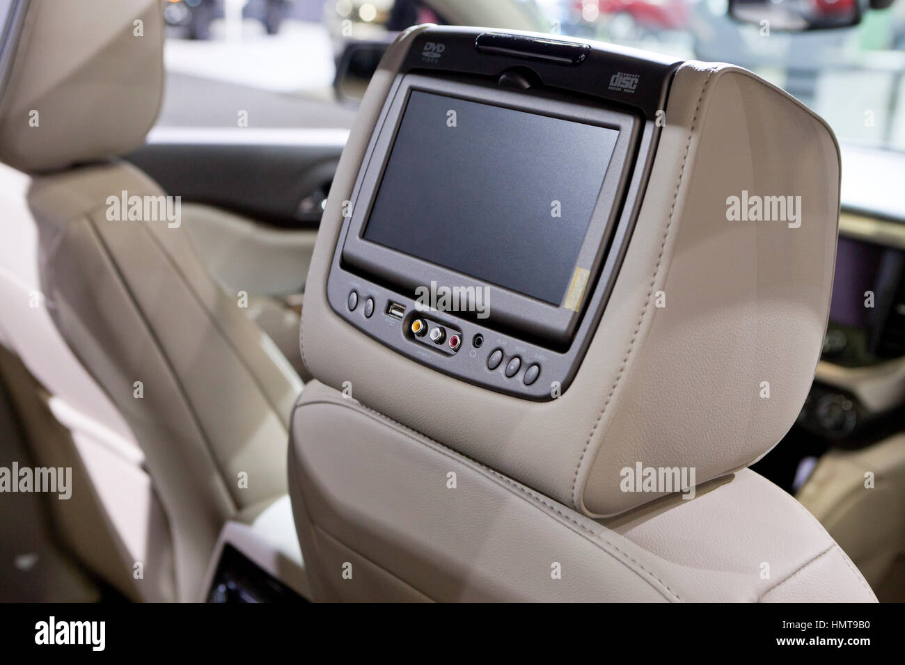 DVD player and monitor mounted on headrest of car - USA Stock Photo