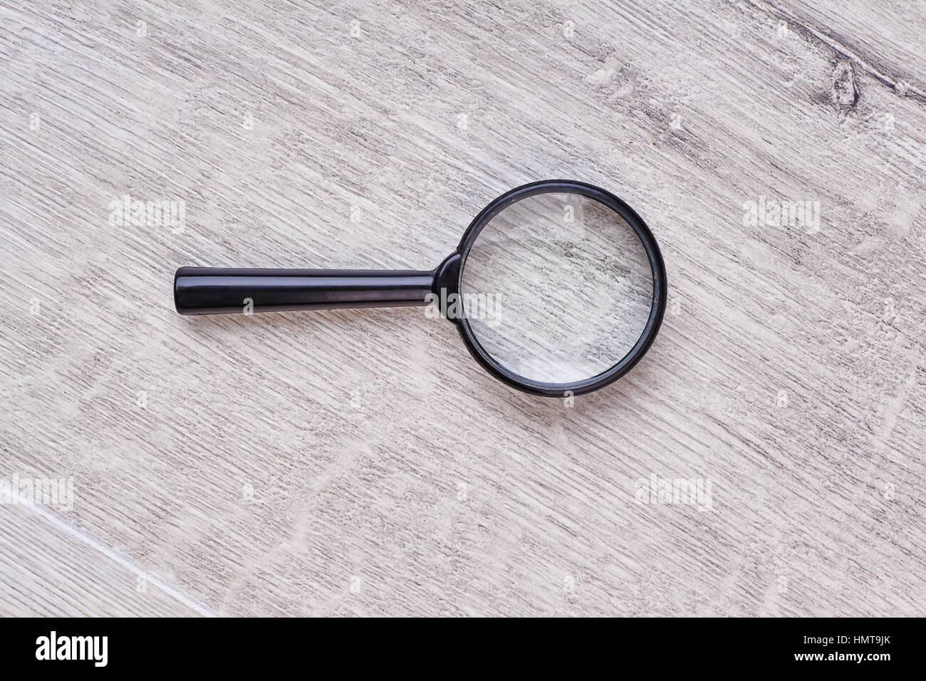 Magnifying glass on wooden backdrop Stock Photo Alamy