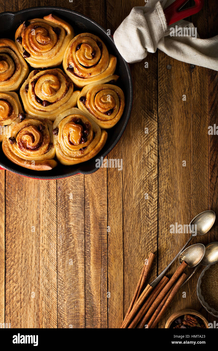 Cinnamon buns with chocolate chips baked in a cast iron pan overhead