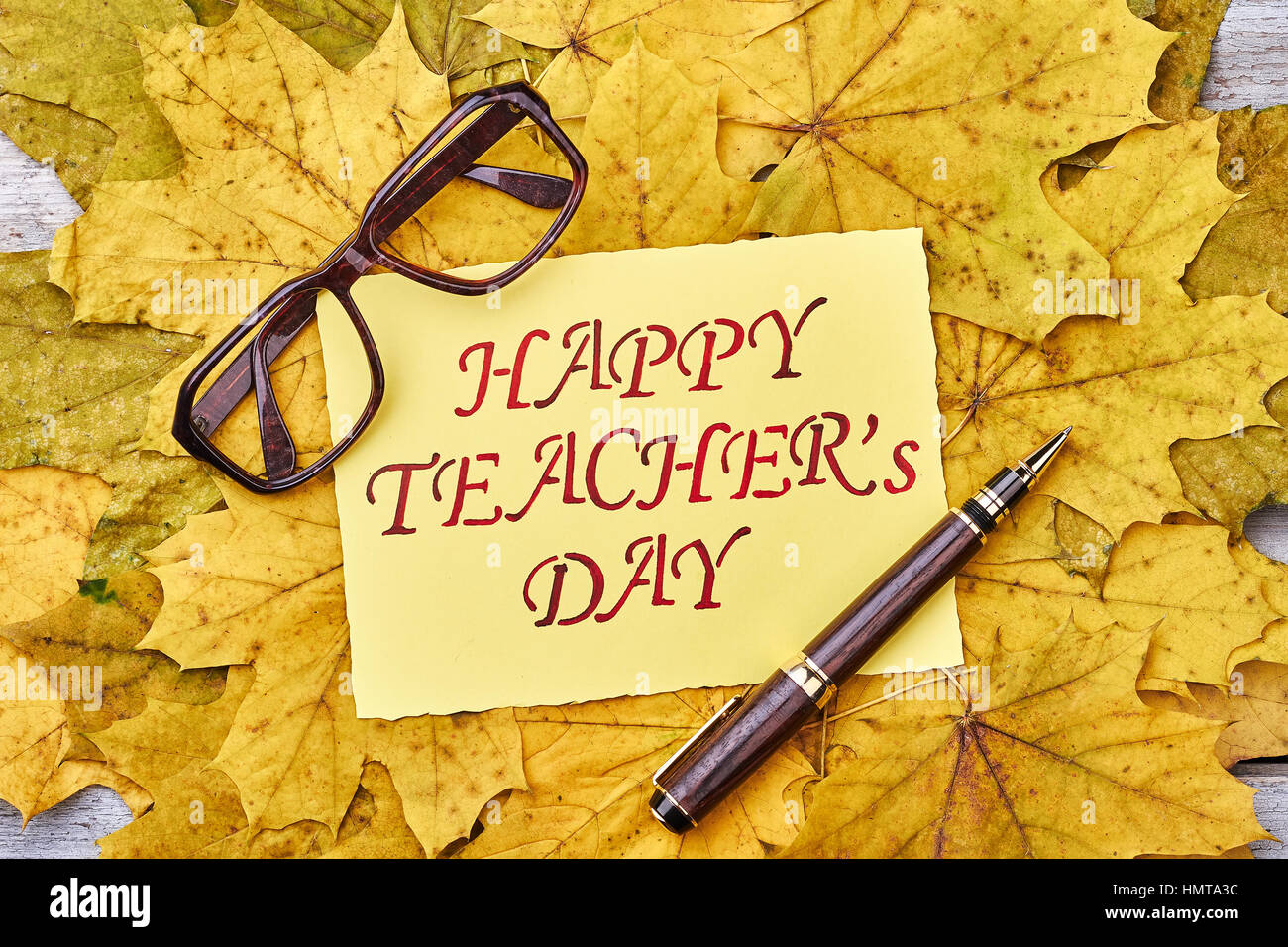 Glasses, pen, leaves and card. Stock Photo