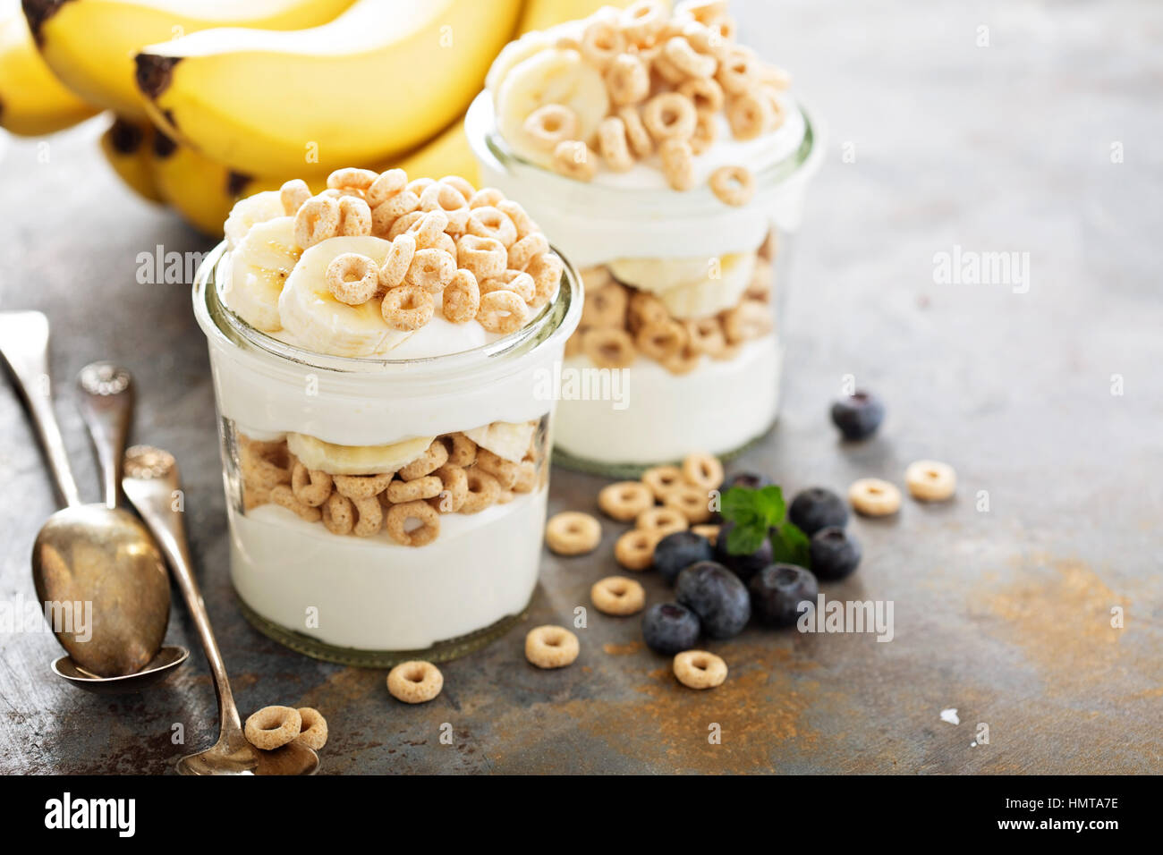 Yogurt parfait with cereal, banana and maple syrup Stock Photo Alamy