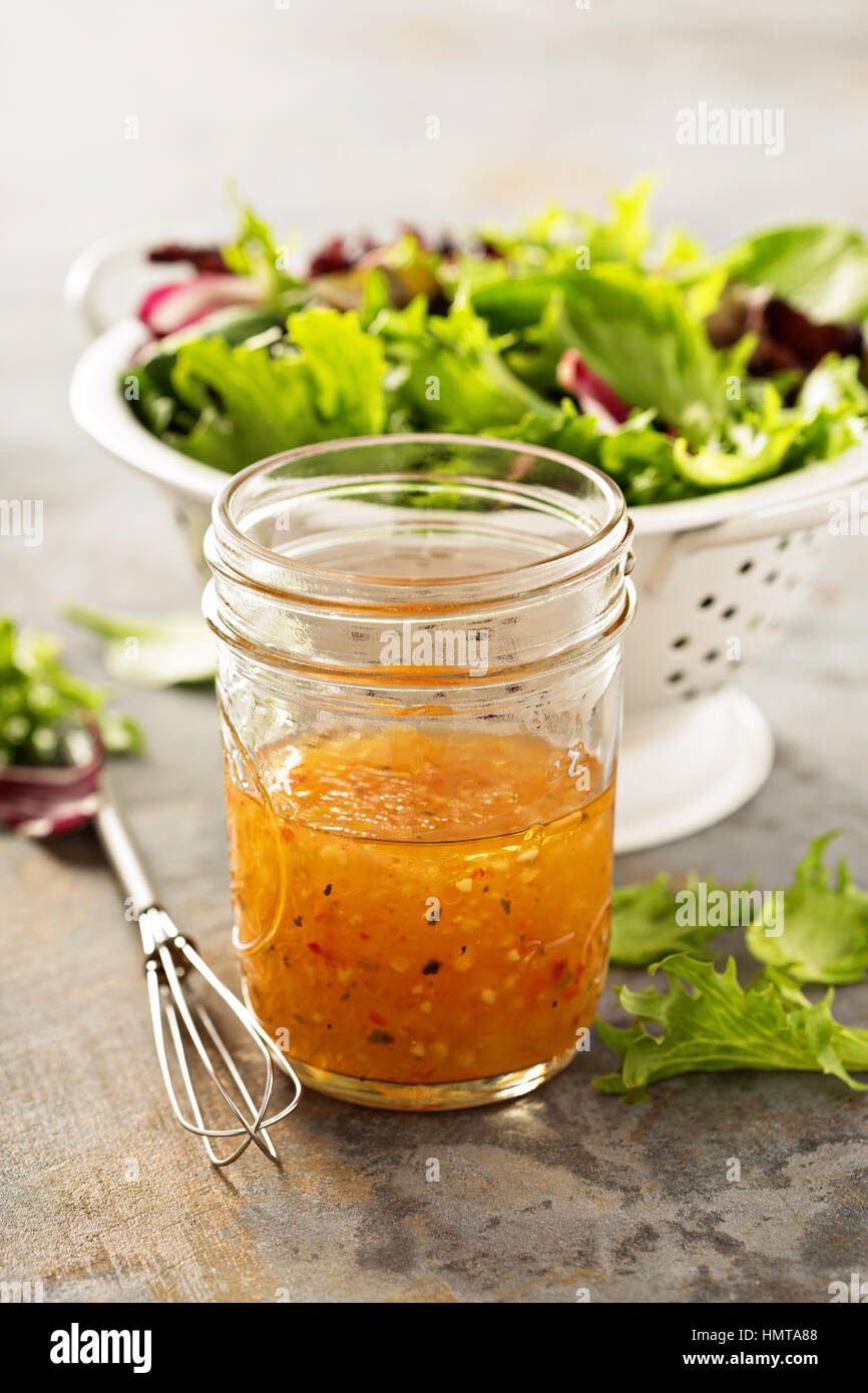Italian vinaigrette dressing in a mason jar with fresh vegetables on