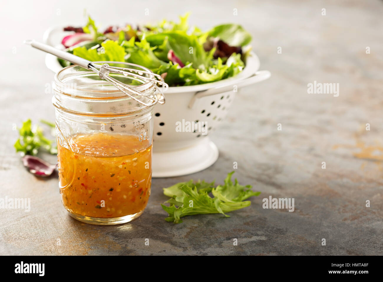 Italian vinaigrette dressing in a mason jar with fresh vegetables on