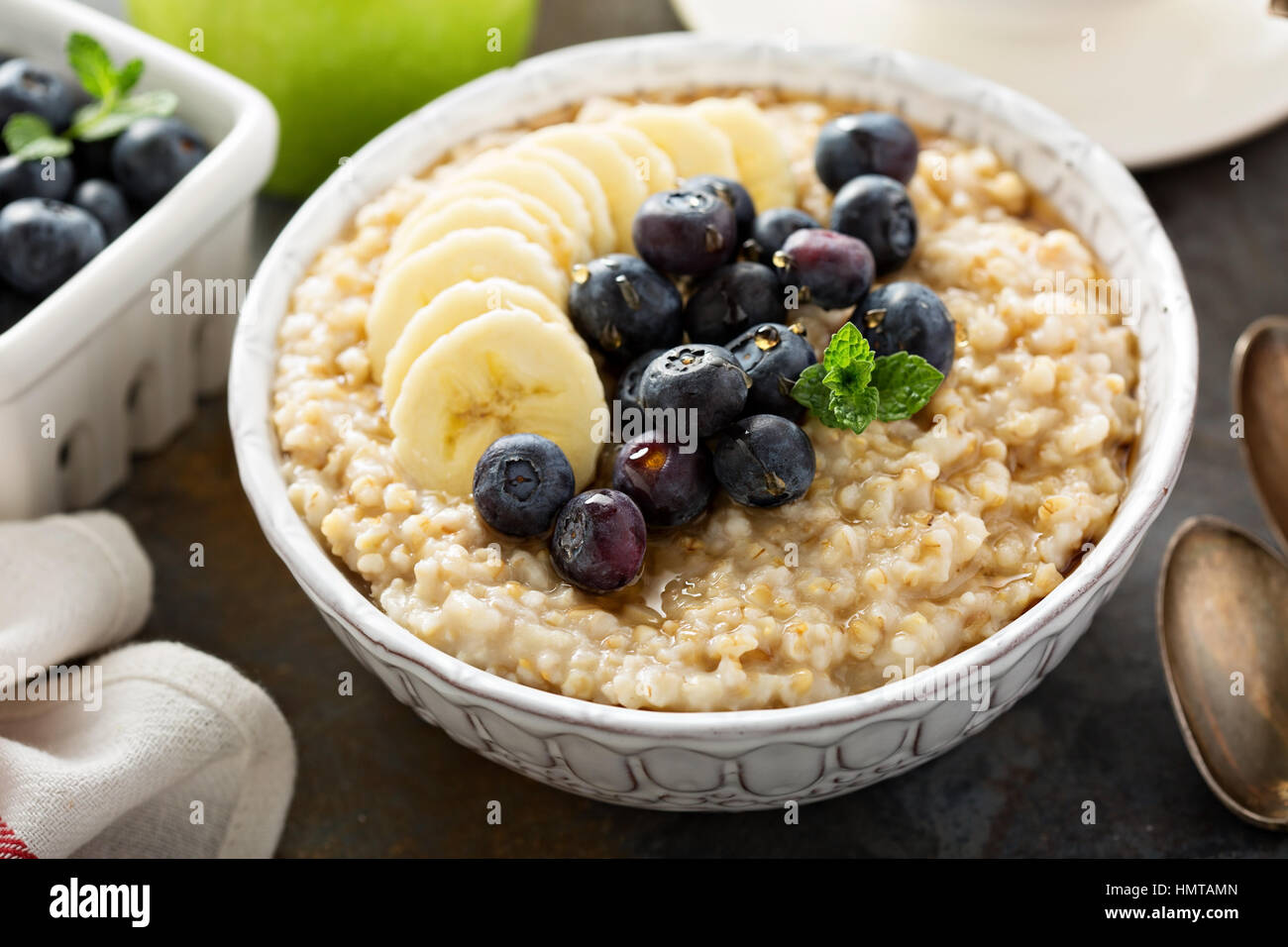 Steel cut oatmeal porridge with banana and blueberry for breakfast