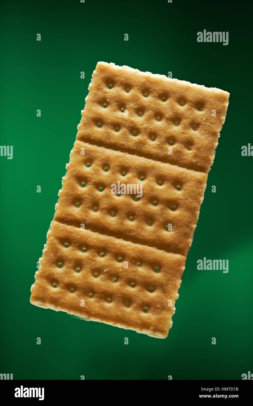one gold cracker isolated on green background Stock Photo