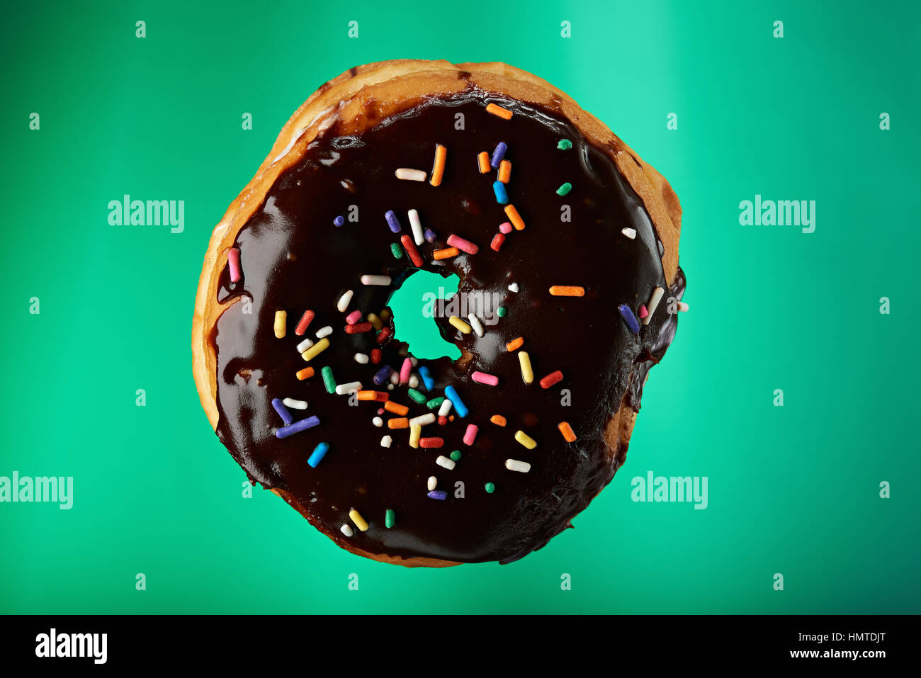 tasty chocolate donut isolated on green background Stock Photo