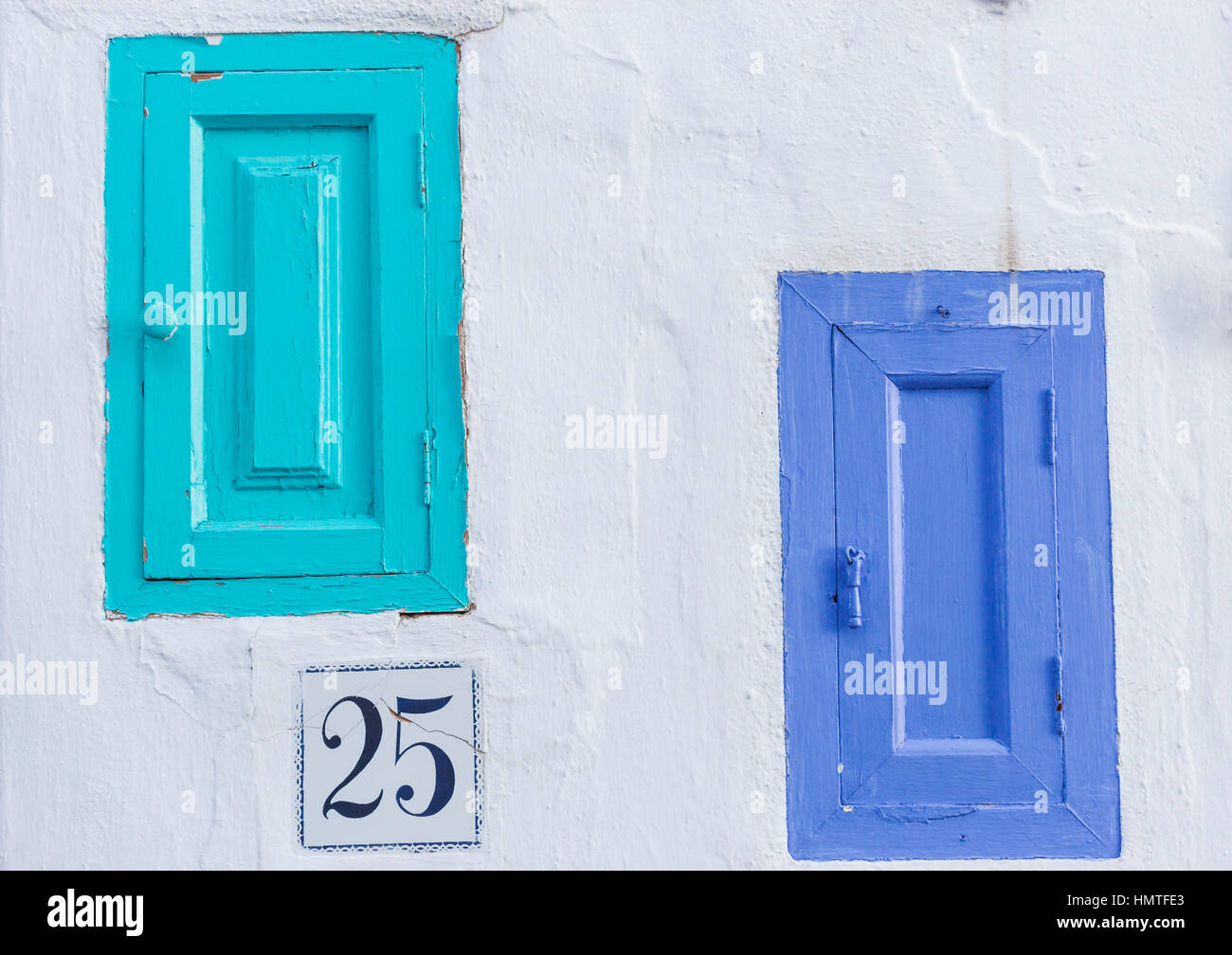 Frigiliana, Malaga Province, Andalusia, southern Spain.  Two blue painted wooden doors set in wall. Stock Photo
