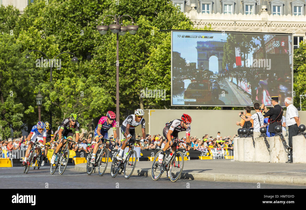 Paris, France - July 24, 2016: The breakaway passing by the Arch de Triomphe on Champs Elysees in Paris during the latest stage of Tour de France 2016 Stock Photo
