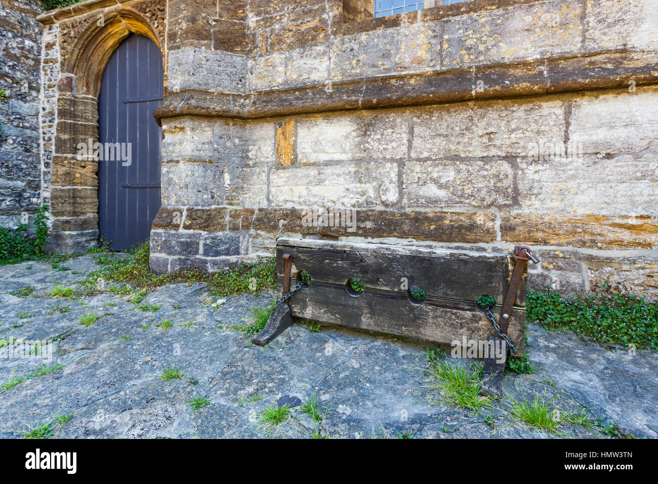 Traditional old wooden stocks in Cerne Abbas, a village in Dorset, south-west England, in summer Stock Photo