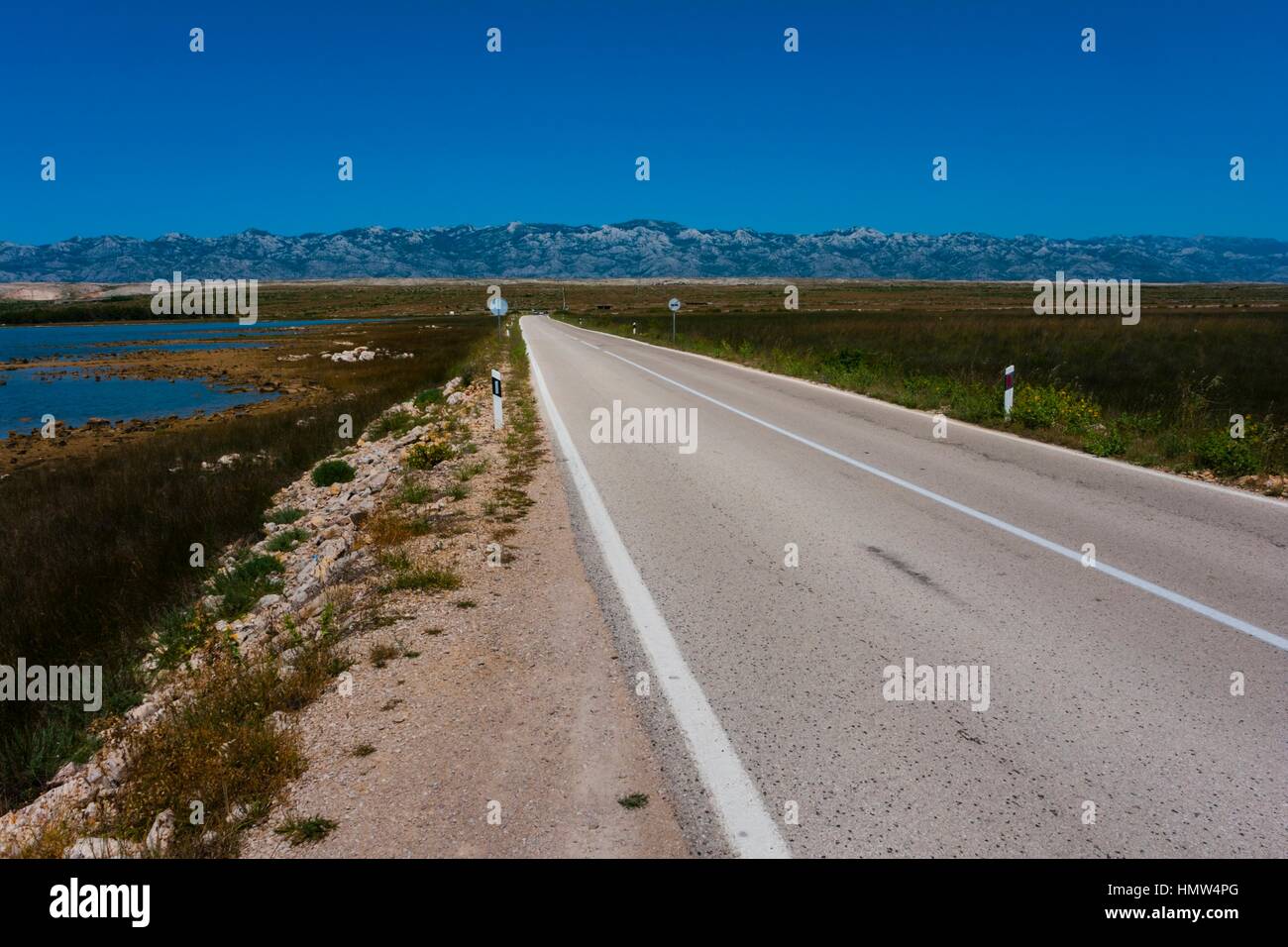 Lonely road on Pag island in Croatia Stock Photo