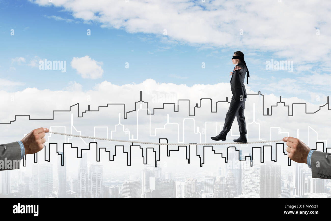 Business concept of risk support and assistance with man balancing on ...