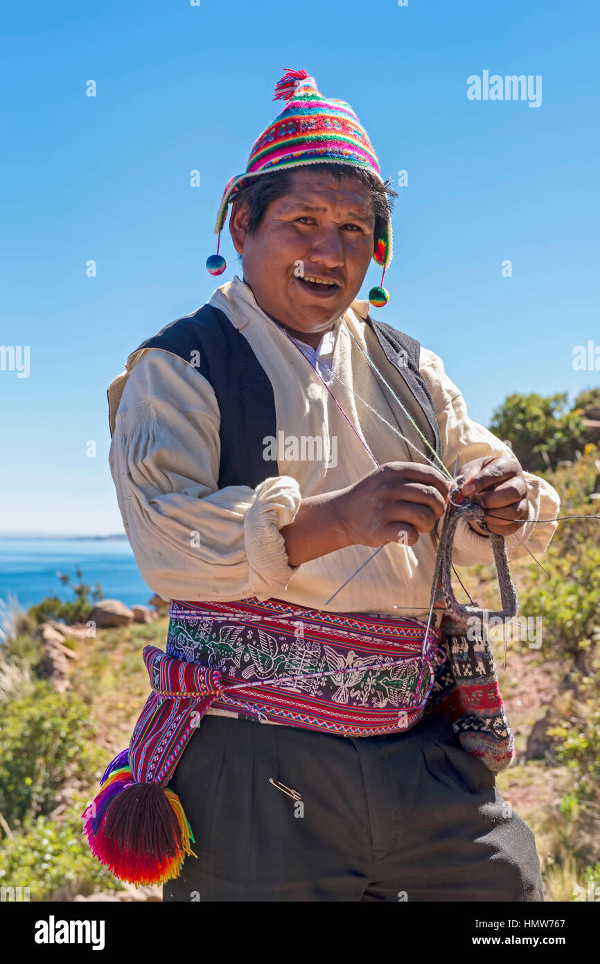 Native man knitting, Taquile Island, Lake Titicaca, Peru Stock Photo