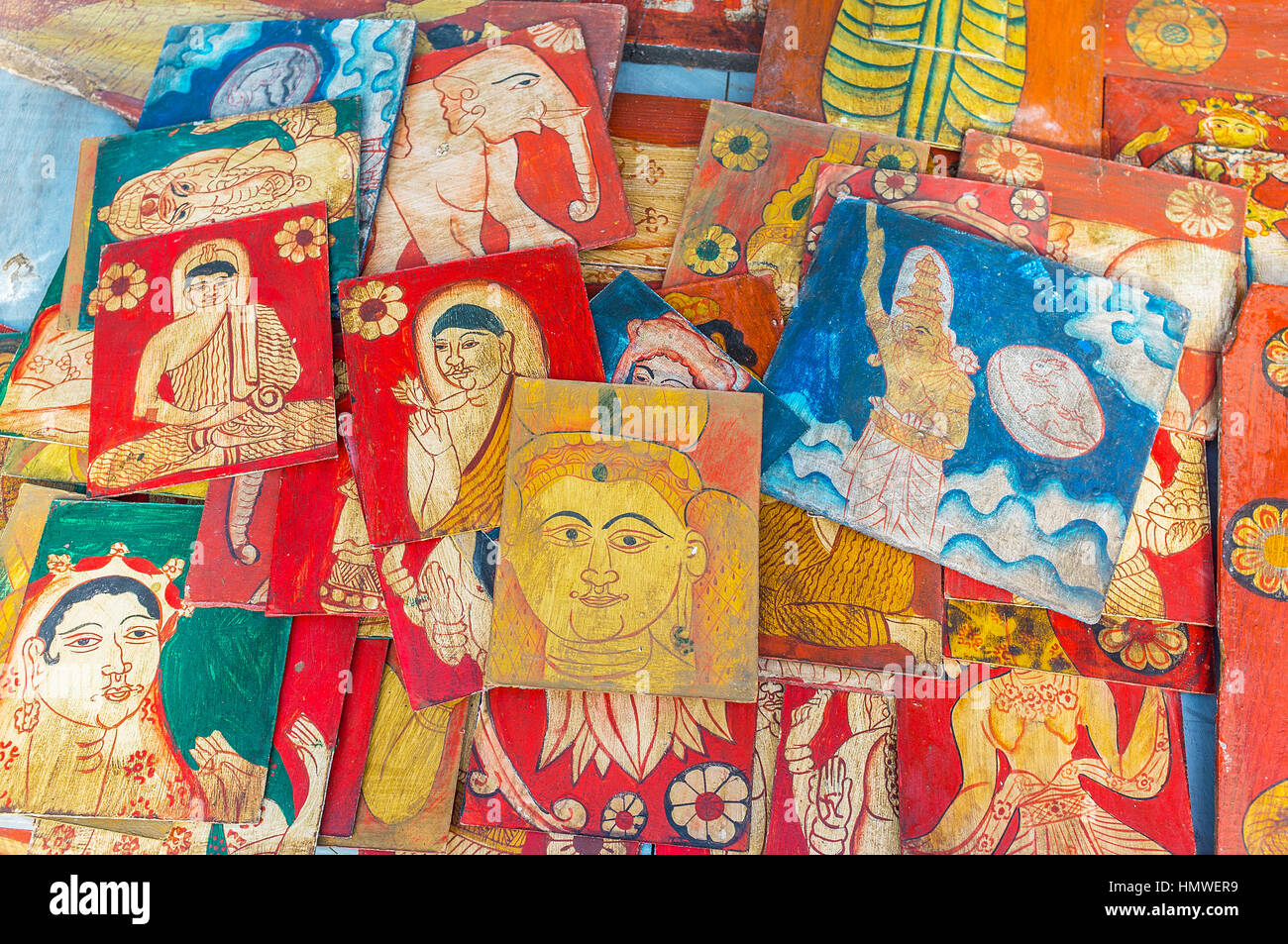 The small wooden boards, covered with vintage paintings of Buddha