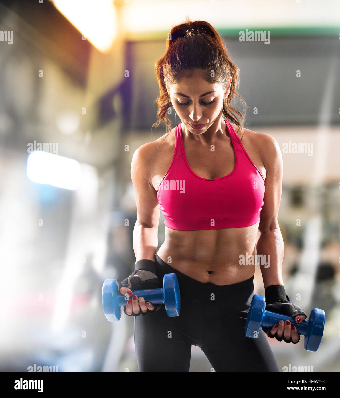 Muscular woman is training at the gym Stock Photo