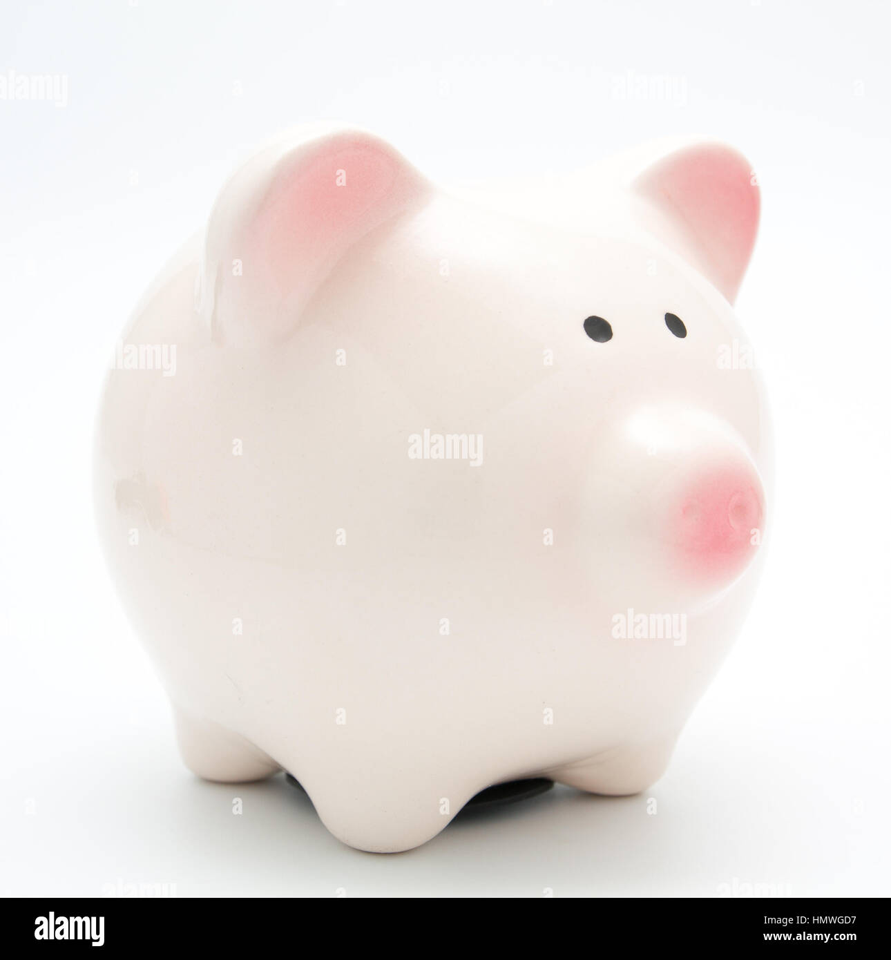 hand putting a coin into piggy bank on white Stock Photo - Alamy