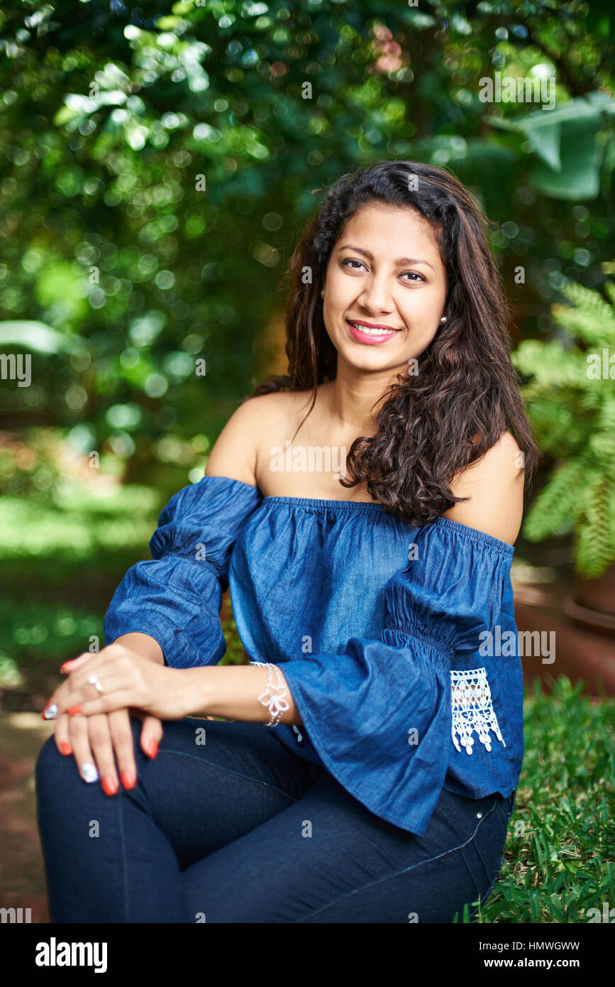 young-latina-girl-sit-in-park-with-blurred-background-stock-photo-alamy