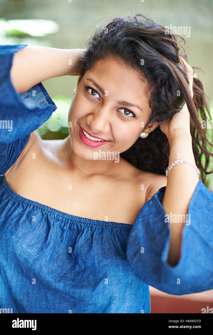 portrait of smiling woman outside in park Stock Photo