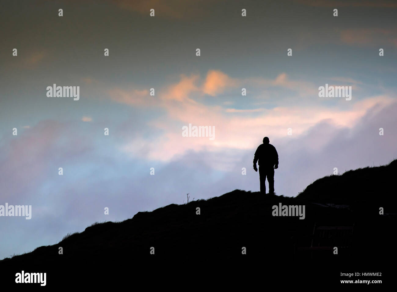 The silhouette of a man walking over Towan Headland in Newquay, Cornwall. Stock Photo
