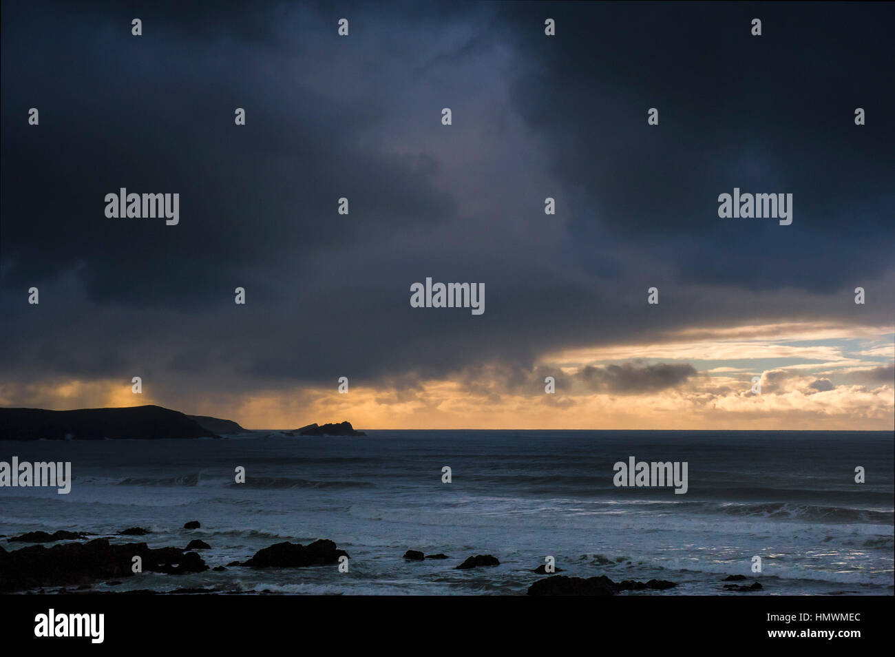 Dark, threatening storm clouds pass over the coast of Newquay on the North Cornwall coast.  UK weather. Stock Photo