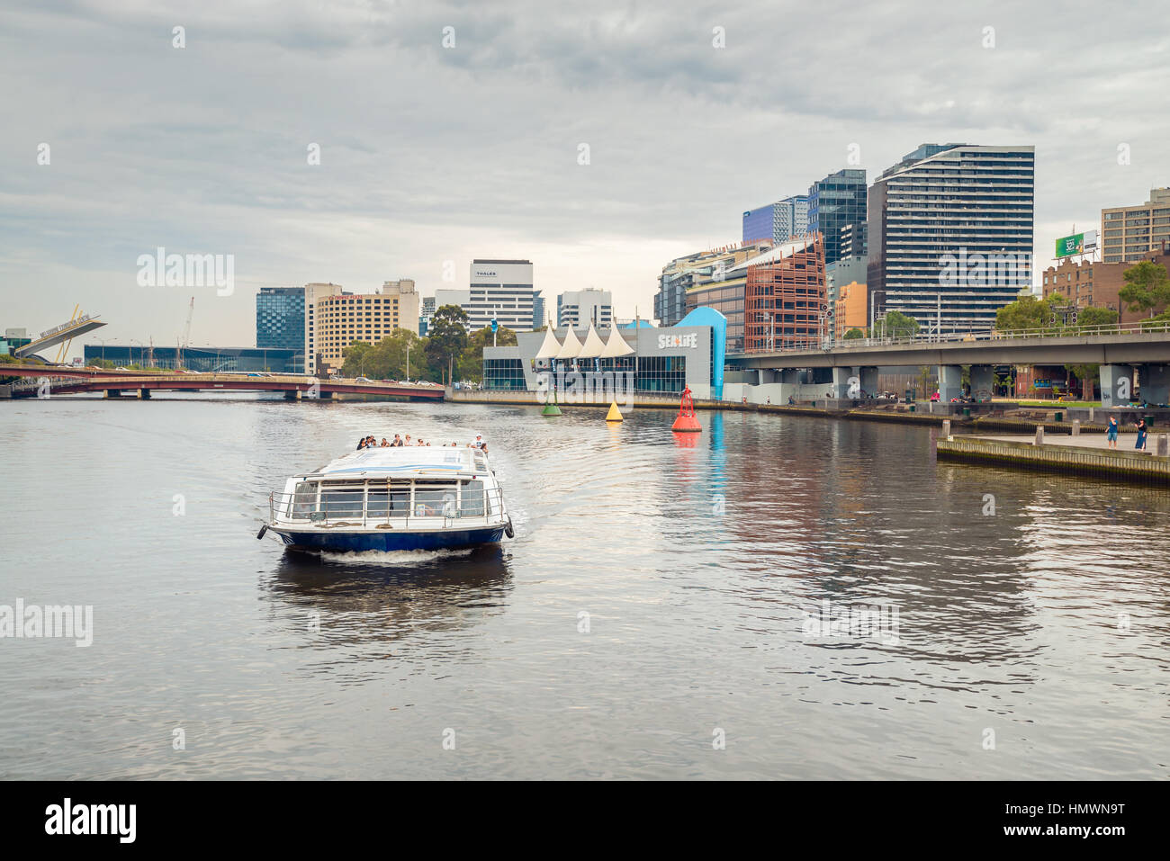 Melbourne, Australia - December 27, 2016: People traveling on Melbourne River Cruises boat along the Yarra river,  Victoria Stock Photo
