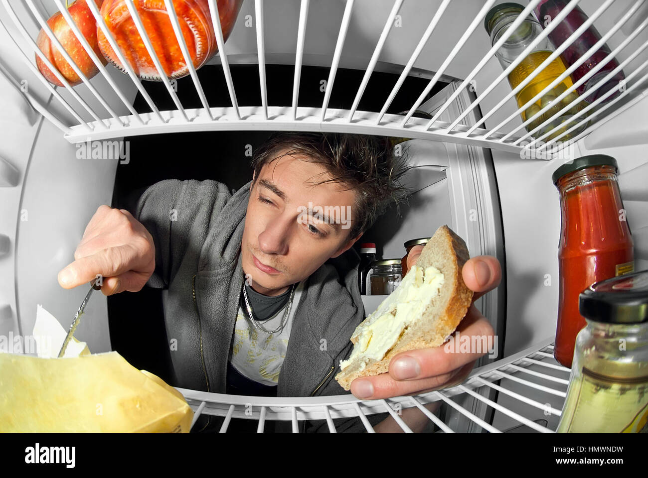 man takes food from the refrigerator Stock Photo Alamy