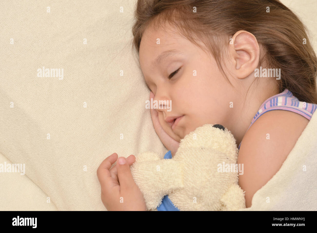 Cute little girl sleeping in a bed Stock Photo - Alamy