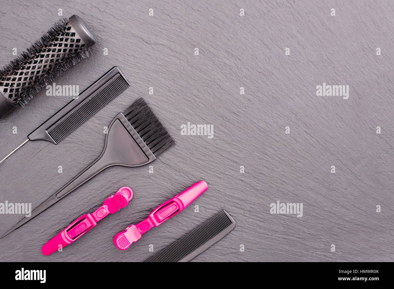 Salon Hairdresser Accessories, pink Comb, application brush,  brashing for cutting hair or colored on a black background. Stock Photo