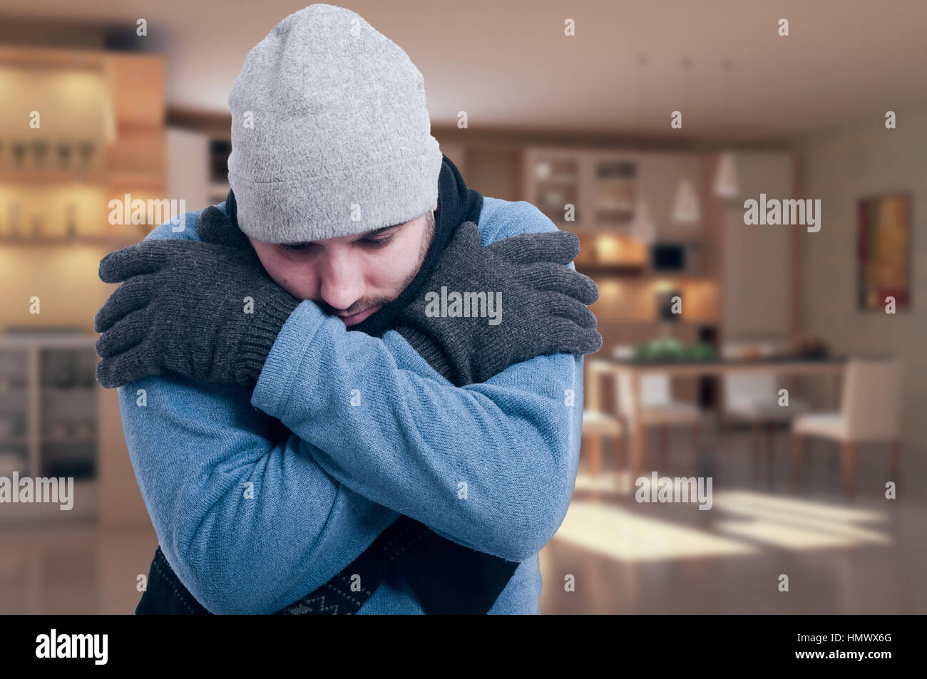 Sad man with medical problem shivering  and feeling sick indoors Stock Photo