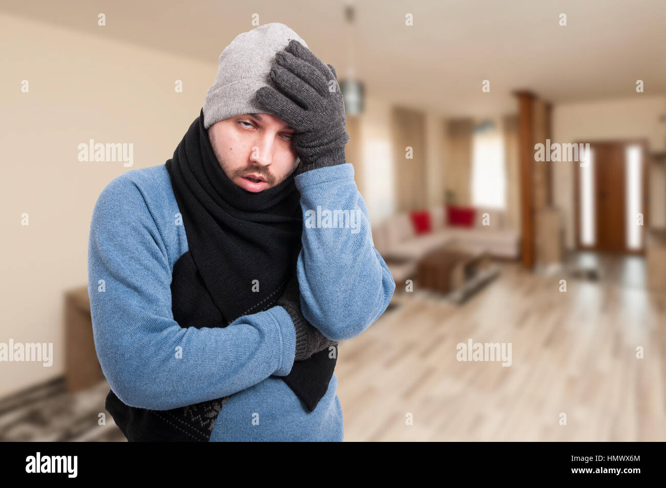Exhausted man feeling bad and having headache beause of winter flu with copy space area Stock Photo