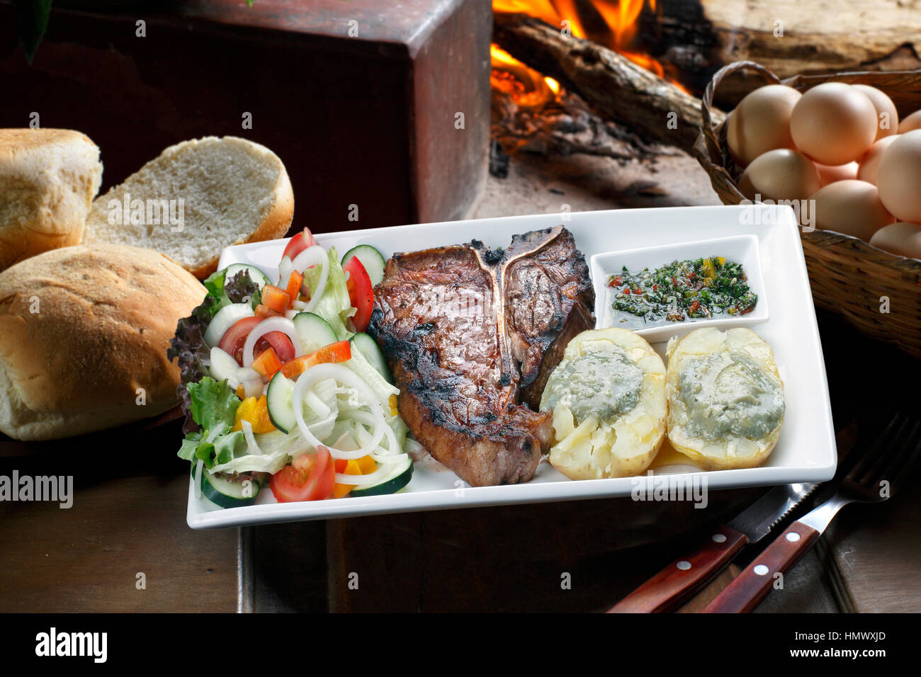 t bone steak with potato salad and vegetables Stock Photo - Alamy