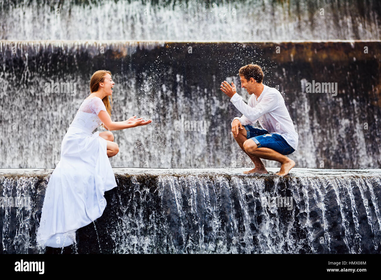 Happy family on honeymoon holidays married loving couple splashing