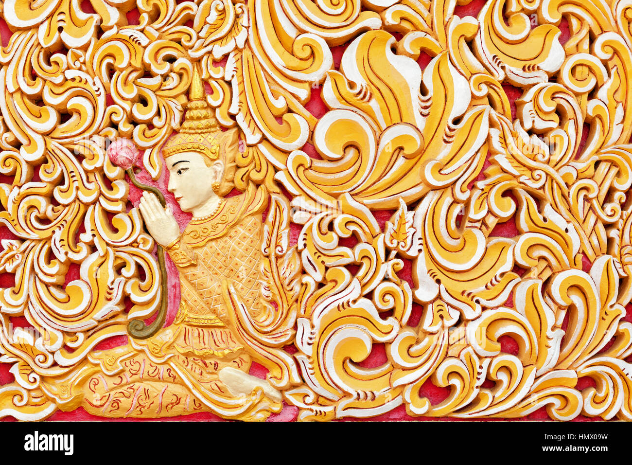 Wall exterior detail of ancient Burmese buddhist temple Dhammikarama in Georgetown on Penang island. Sitting in meditating pose Buddha. Stock Photo