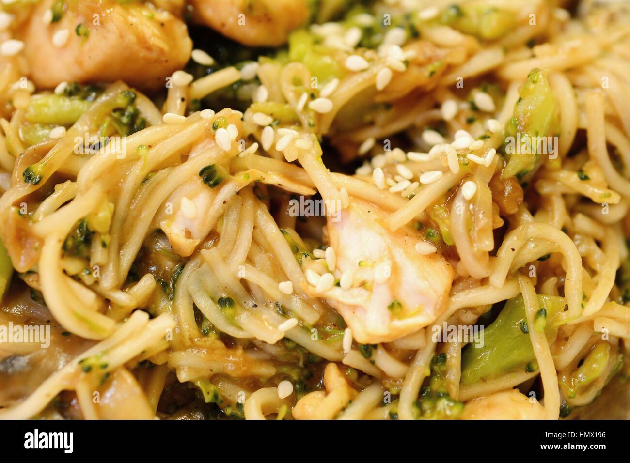 Chinese noodles with chicken meat, broccoli and vegetables. Stock Photo