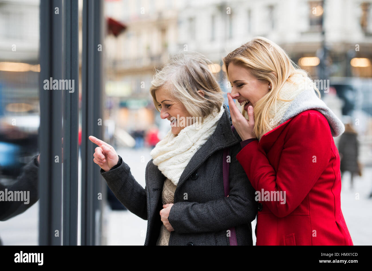Women window shopping in centre of the city. Winter Stock Photo