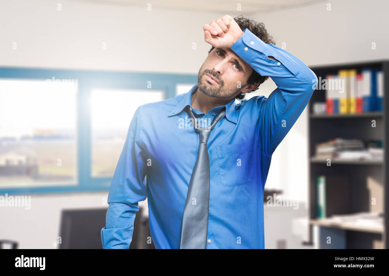 Sweating businessman due to hot climate Stock Photo - Alamy