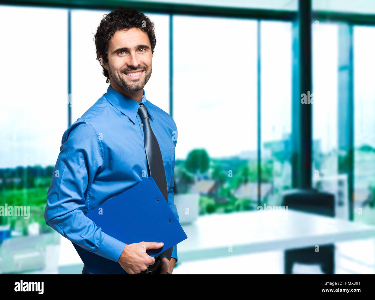 Handsome businessman at his desk in the office Stock Photo Alamy