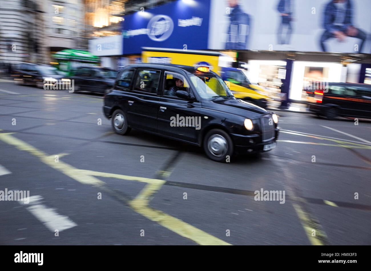 A taxi drives across Piccadilly Circus in Central London Stock Photo