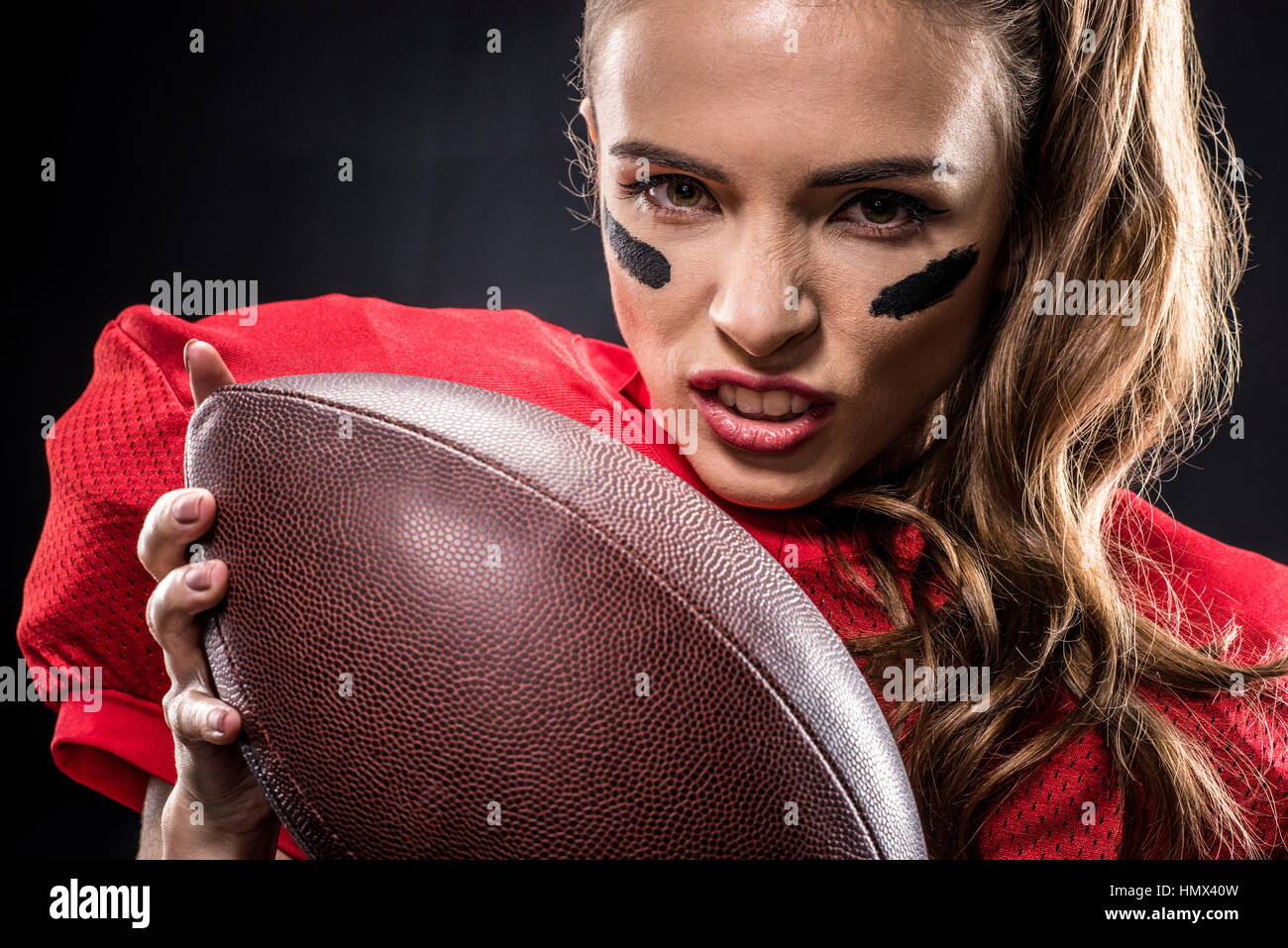 American football player holding ball Stock Photo Alamy