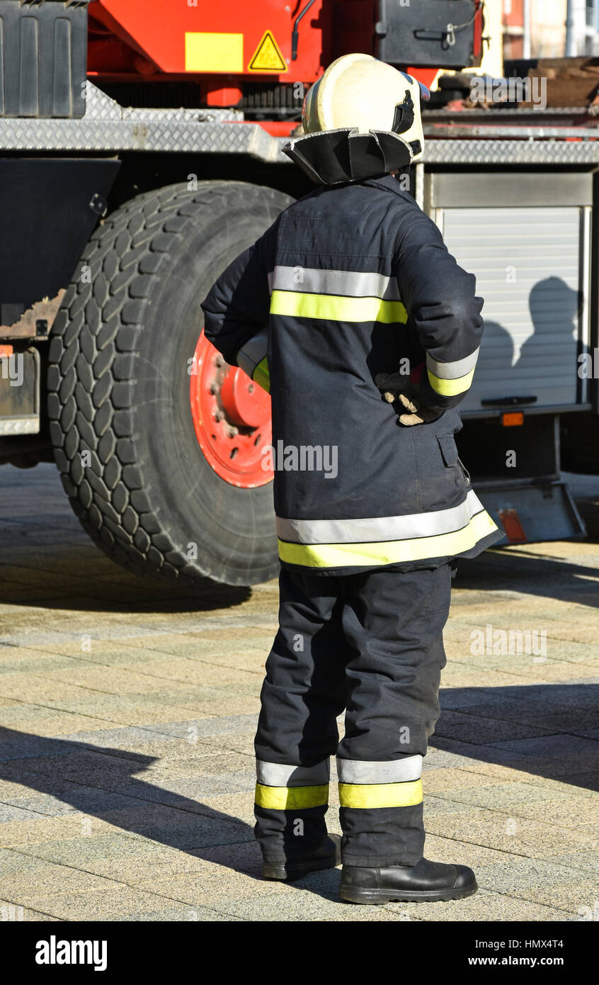 Firefighter stands next to a vehicle Stock Photo