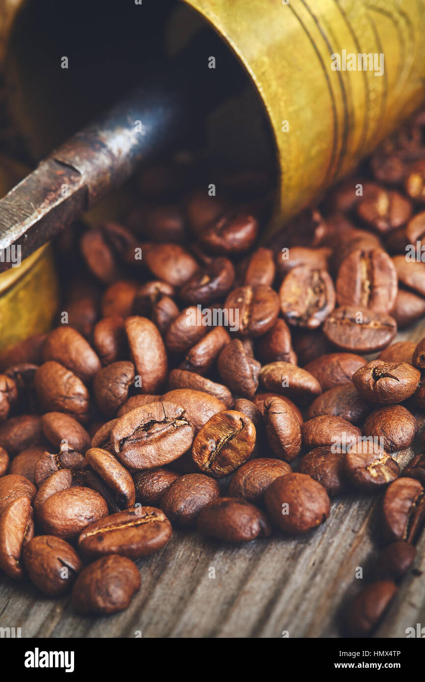 https://c8.alamy.com/comp/HMX4TP/antique-coffee-grinder-and-roasted-coffee-beans-on-rustic-wooden-background-HMX4TP.jpg