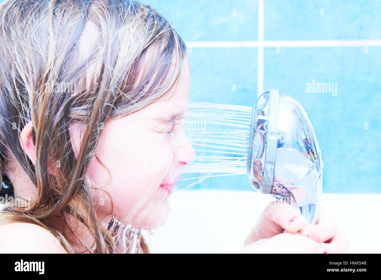 Child Girl Pours Water From The Shower At Her Face In Bathtub Stock Photo Alamy