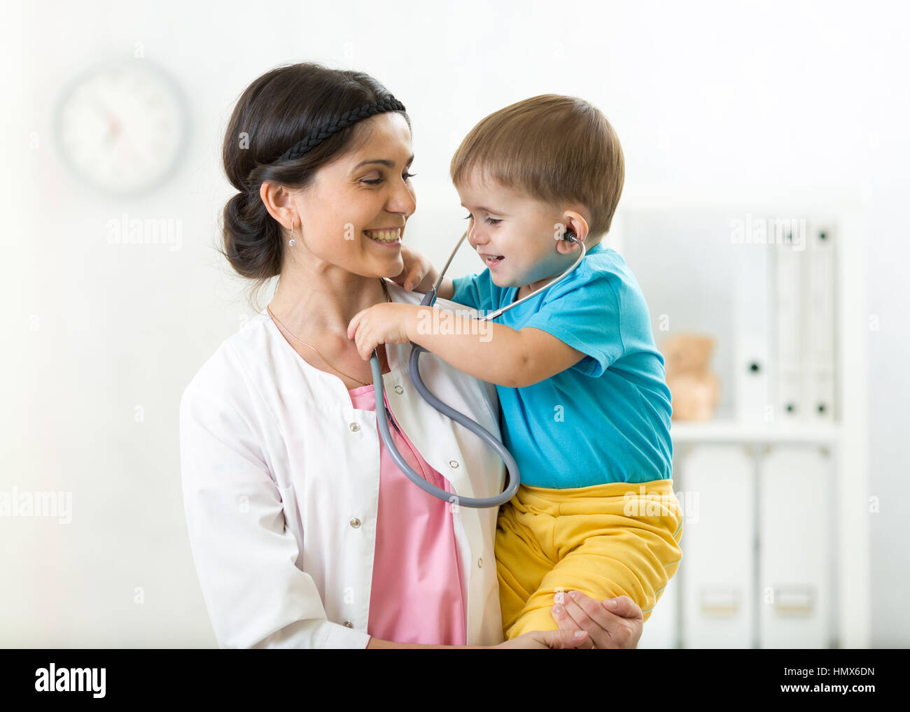Little boy and young female doctor in hospital having examination Stock Photo