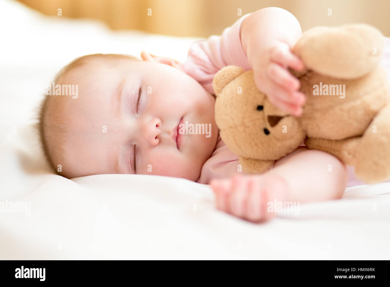 infant baby sleeping with plush toy Stock Photo