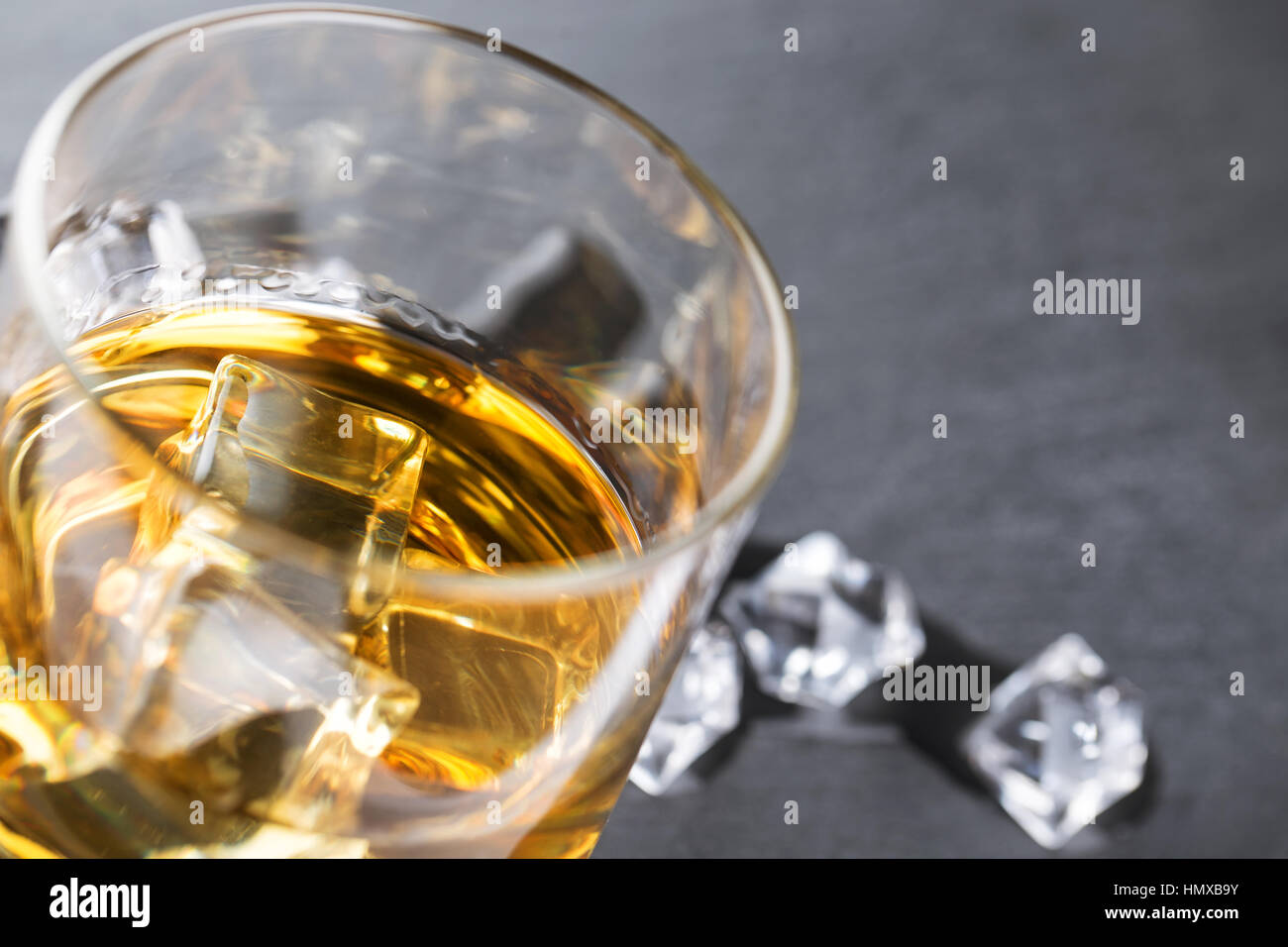 Detail of glass of whiskey and ice cubes Stock Photo Alamy